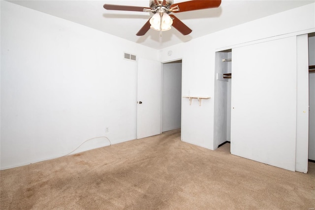 unfurnished bedroom with ceiling fan and light colored carpet