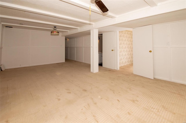 basement with carpet floors and ceiling fan