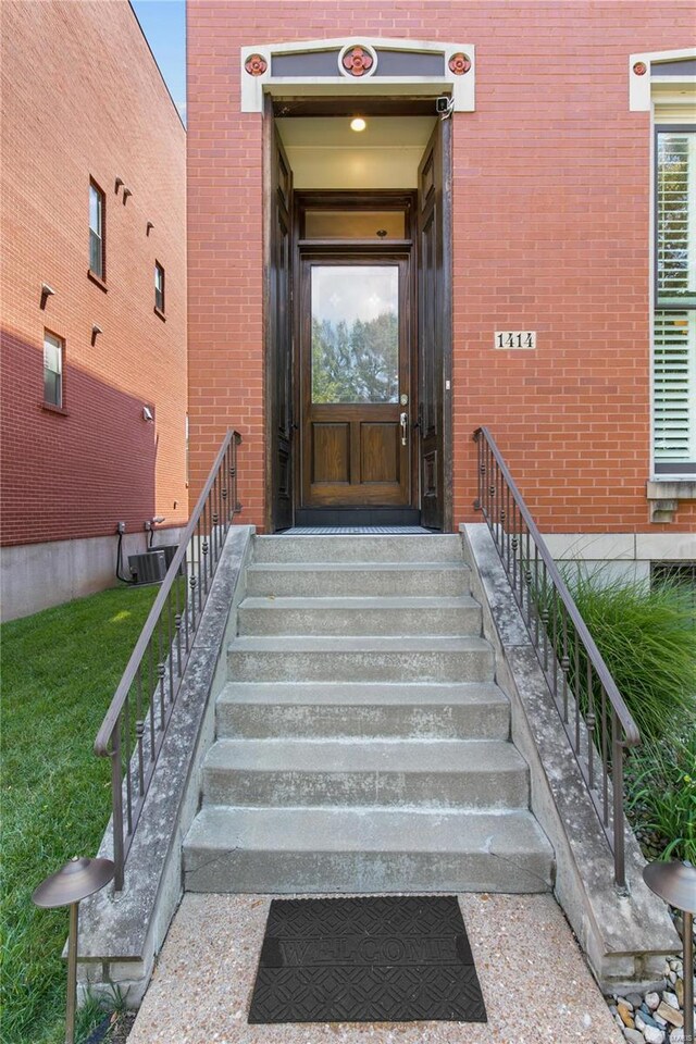 doorway to property featuring cooling unit