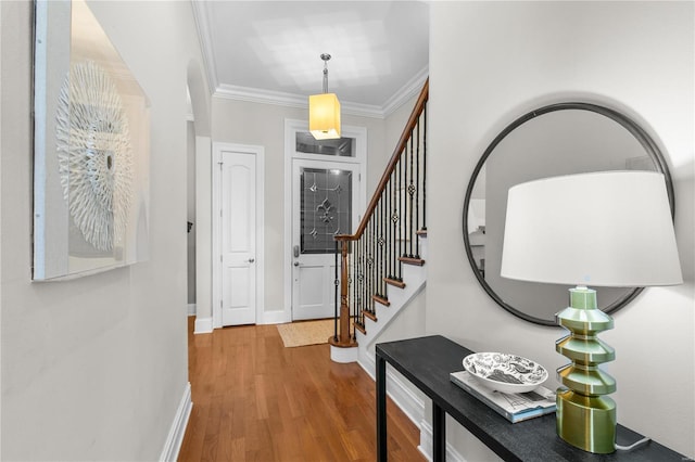 foyer with hardwood / wood-style flooring and ornamental molding