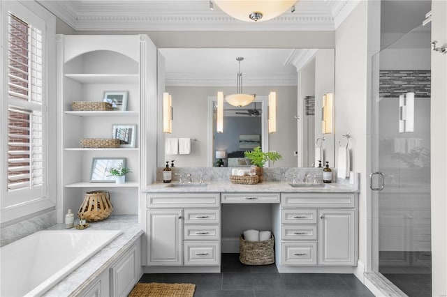 bathroom with built in shelves, tile patterned flooring, plus walk in shower, crown molding, and double sink vanity