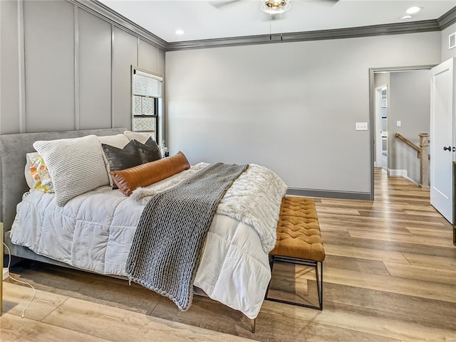 bedroom featuring ceiling fan, light wood-type flooring, and ornamental molding