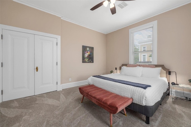 bedroom with carpet floors, ceiling fan, ornamental molding, and a closet