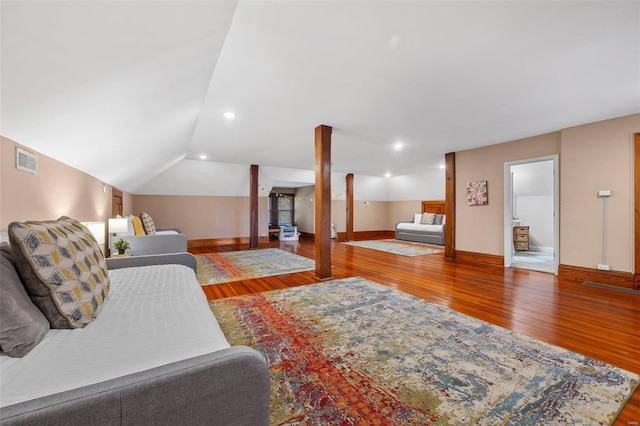 living room featuring vaulted ceiling and wood-type flooring