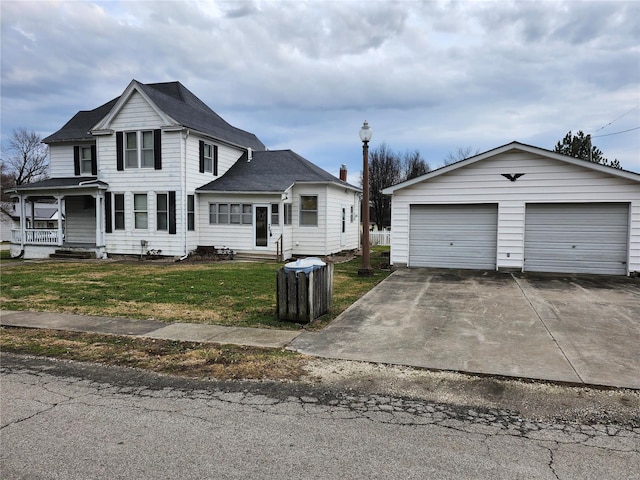 view of front facade featuring a front yard, covered porch, an outdoor structure, and a garage