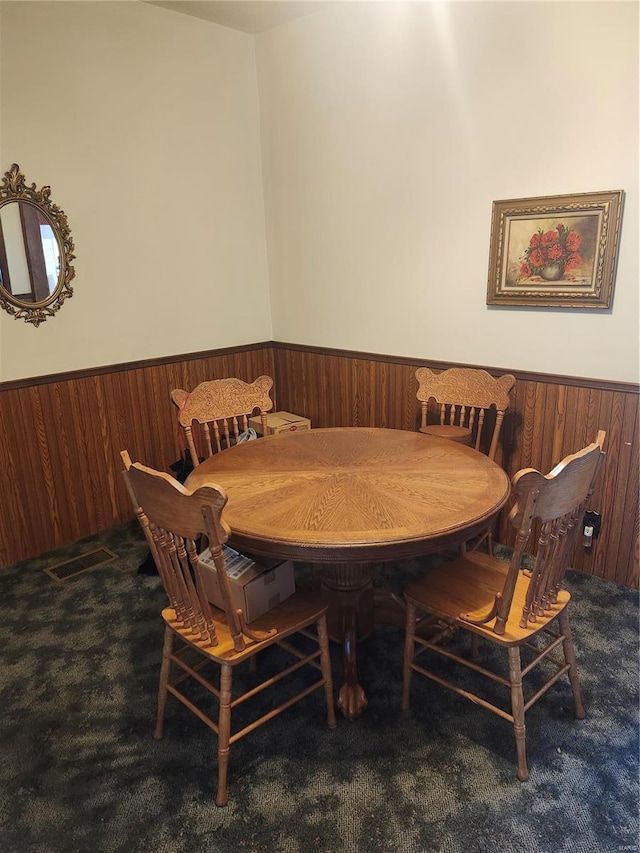 dining area featuring dark colored carpet