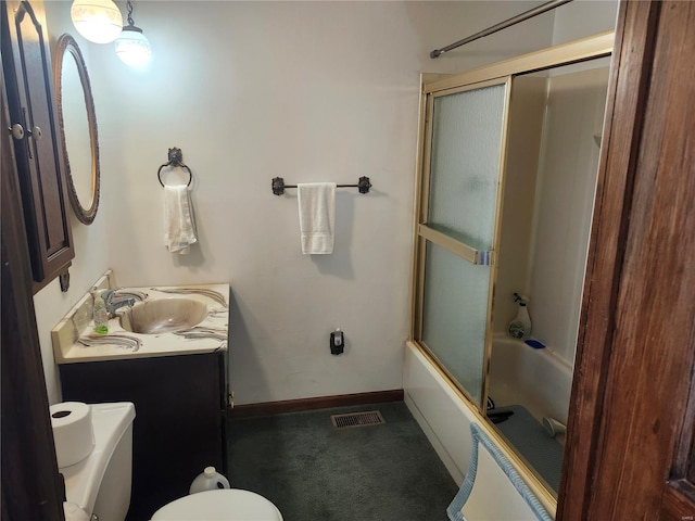 full bathroom featuring toilet, combined bath / shower with glass door, and vanity