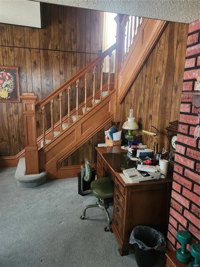 office area featuring carpet flooring and wood walls