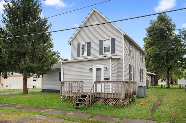 back of house with a wooden deck, central AC unit, and a yard