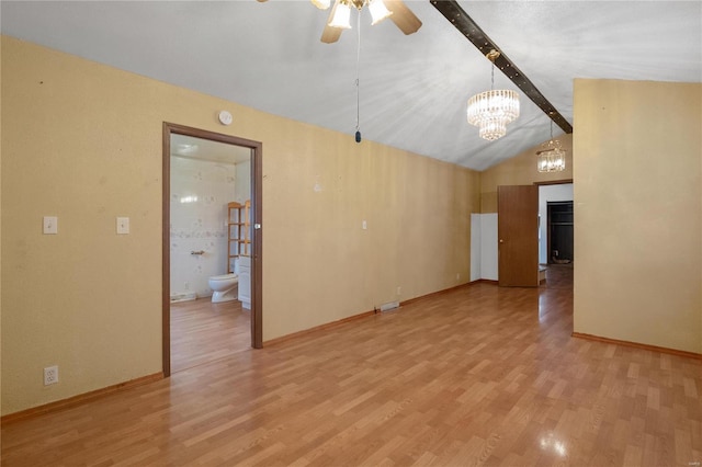 interior space featuring vaulted ceiling with beams, ceiling fan with notable chandelier, and light hardwood / wood-style flooring