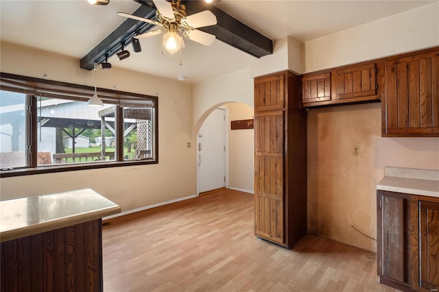 kitchen with beam ceiling, pendant lighting, ceiling fan, and light hardwood / wood-style flooring