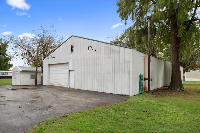 garage featuring a lawn