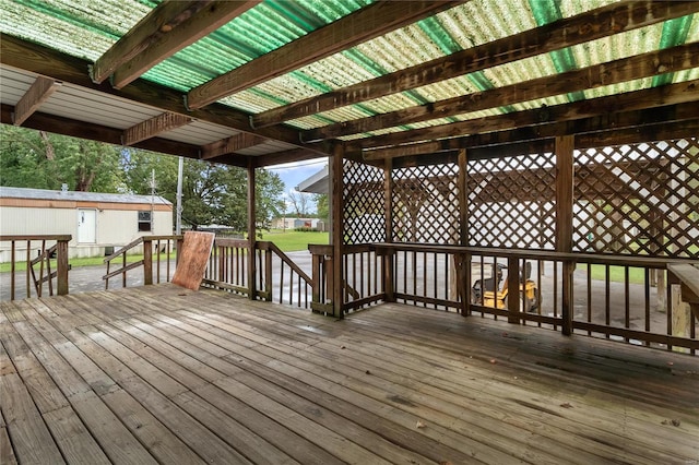 wooden terrace featuring a shed