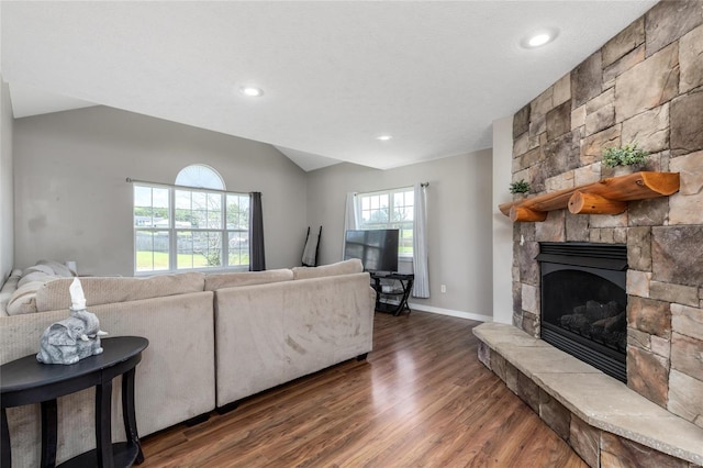 living room featuring a fireplace, a textured ceiling, and dark wood-type flooring