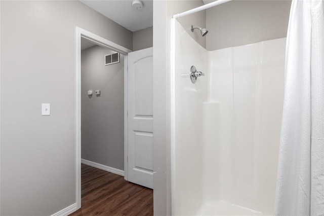 bathroom featuring a shower with shower curtain and wood-type flooring