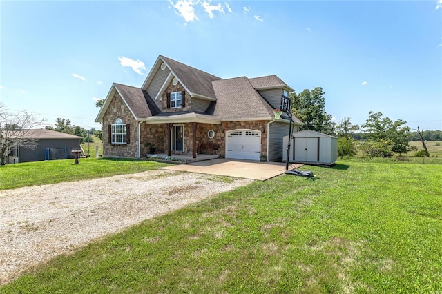 view of front of property with a storage unit, a front lawn, and a garage