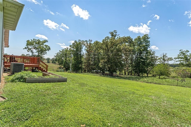 view of yard featuring central AC unit and a deck