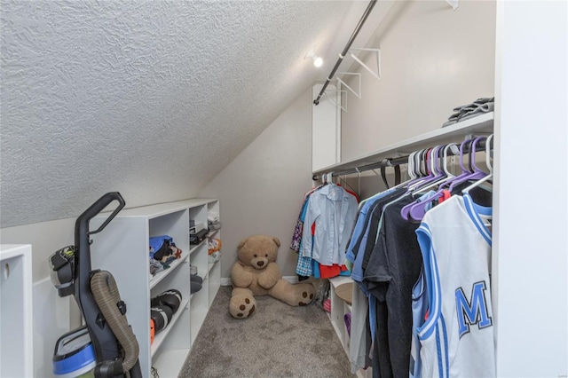 walk in closet featuring carpet flooring and lofted ceiling