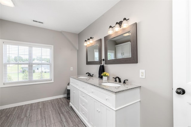 bathroom featuring dual vanity