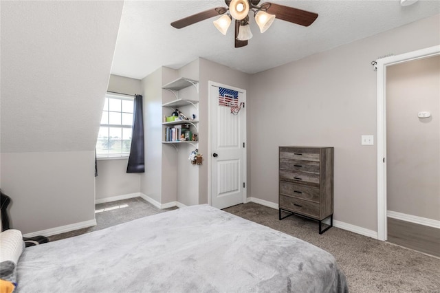 carpeted bedroom featuring a textured ceiling and ceiling fan