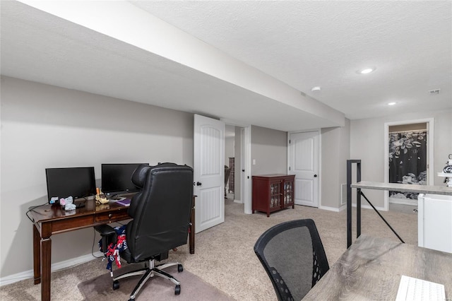 carpeted office space featuring a textured ceiling