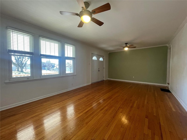 interior space with hardwood / wood-style flooring, ceiling fan, and crown molding