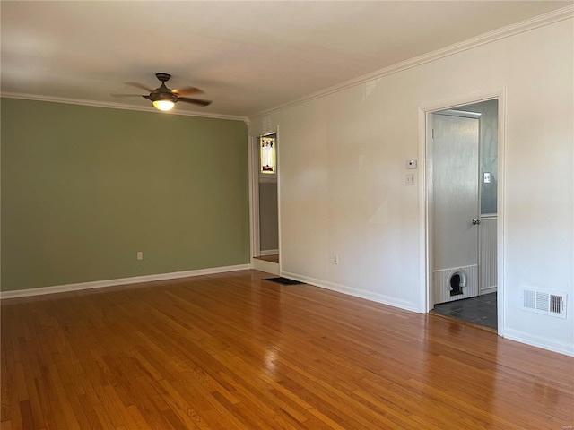 unfurnished room with ceiling fan, dark wood-type flooring, and ornamental molding