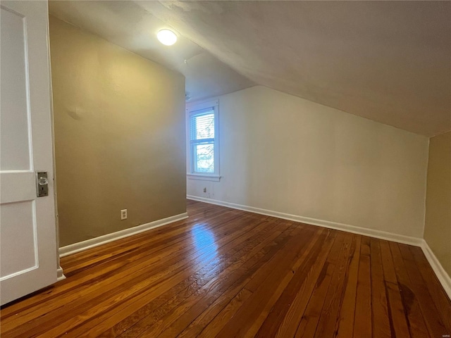 bonus room featuring vaulted ceiling and hardwood / wood-style flooring