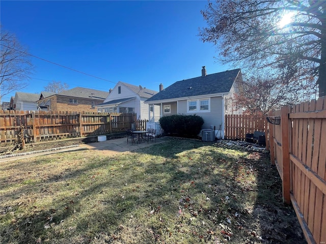 back of house featuring a patio, a lawn, and central air condition unit