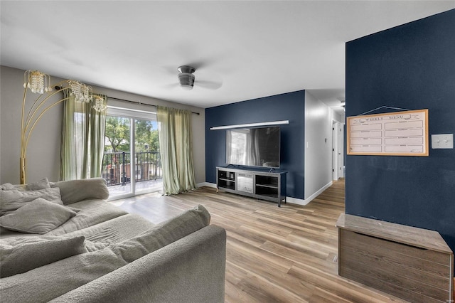 living room featuring hardwood / wood-style floors and ceiling fan