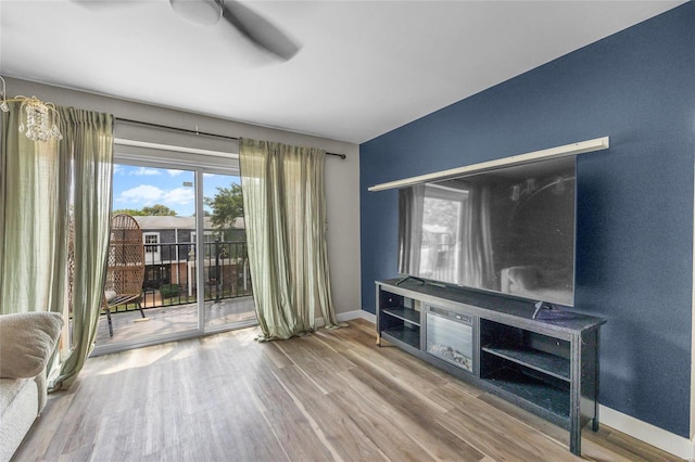 unfurnished living room with ceiling fan and wood-type flooring