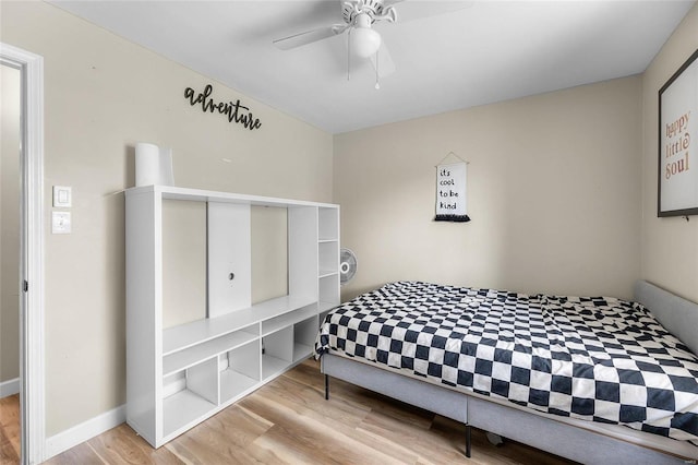 bedroom with light hardwood / wood-style flooring and ceiling fan