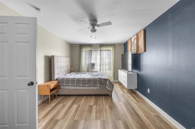 bedroom with light hardwood / wood-style flooring and ceiling fan