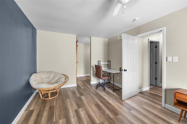 office area with wood-type flooring and ceiling fan