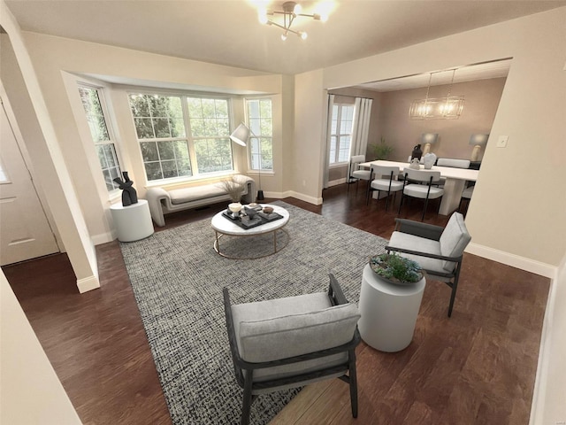 living room featuring a chandelier and dark wood-type flooring