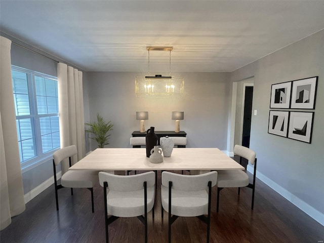 dining area featuring an inviting chandelier and dark hardwood / wood-style floors