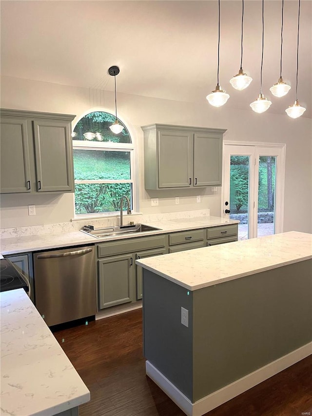 kitchen featuring dark hardwood / wood-style floors, hanging light fixtures, stainless steel appliances, and sink