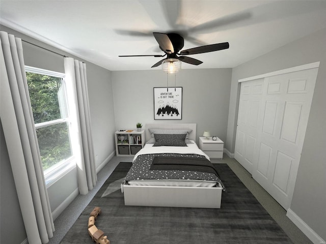 carpeted bedroom featuring a closet and ceiling fan