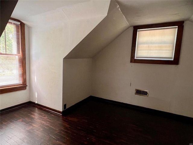 bonus room featuring vaulted ceiling and hardwood / wood-style flooring