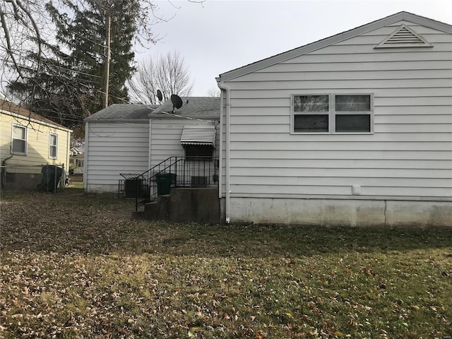 exterior space with roof with shingles