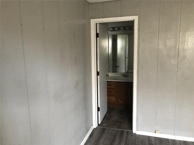 corridor featuring dark wood finished floors