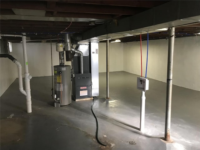 basement featuring water heater and heating unit