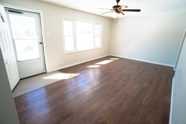 spare room with ceiling fan and dark hardwood / wood-style floors