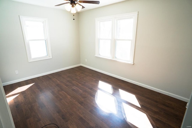 unfurnished room with ceiling fan, a wealth of natural light, and dark hardwood / wood-style floors