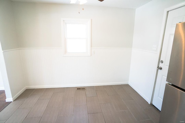 spare room featuring hardwood / wood-style flooring and ceiling fan