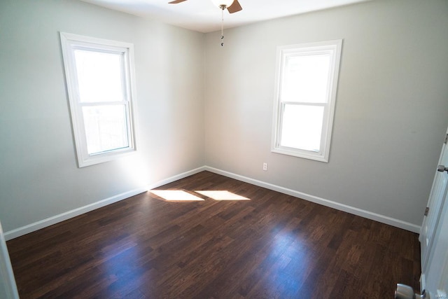 unfurnished room with ceiling fan, baseboards, and dark wood-style flooring