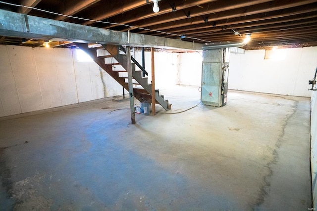 basement featuring heating unit and a wealth of natural light