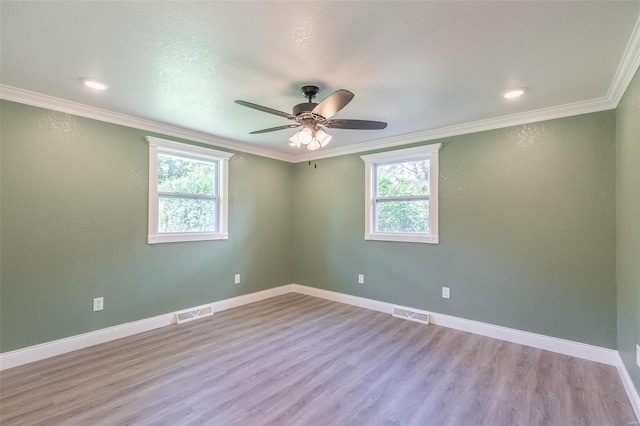 unfurnished room with a textured ceiling, light hardwood / wood-style floors, ornamental molding, and ceiling fan