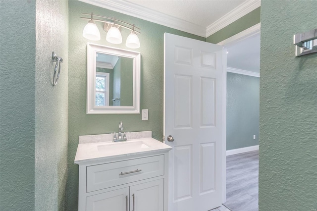 bathroom featuring vanity, crown molding, and hardwood / wood-style floors