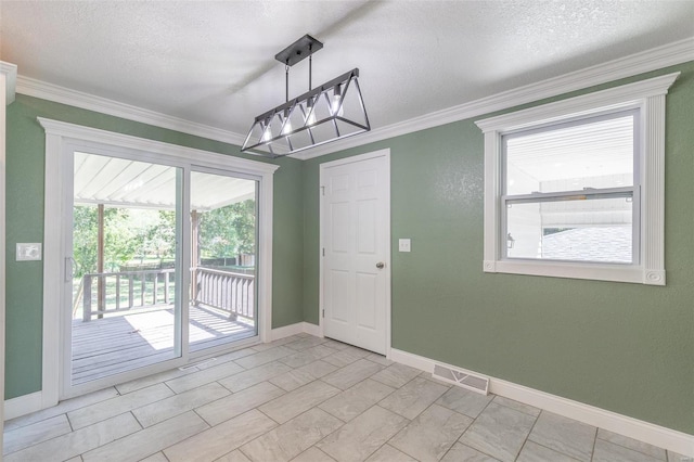 unfurnished room with a textured ceiling and crown molding